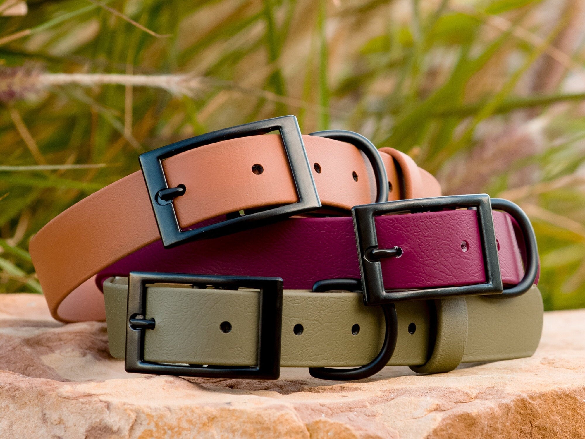 Stack of three biothane dog collars with matte black buckles