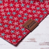 red dog bandana with white stars outlined in red and blue